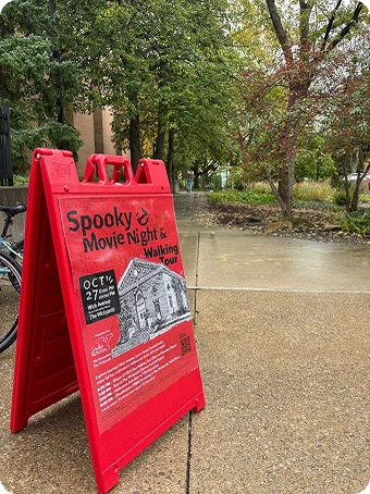 An outdoor A-frame sign promoting the haunted tour